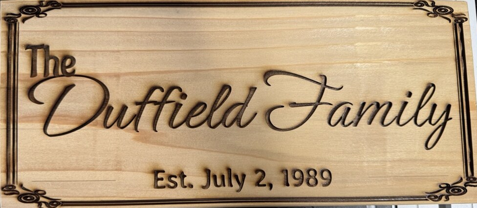 The Duffield Family sign engraved in cedar