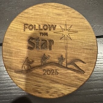 Round wood coaster engraved with Follow the Star 2025